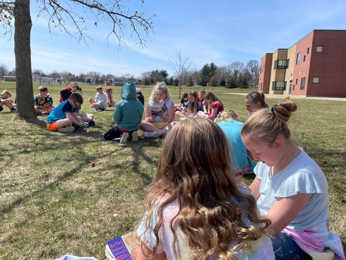 Kids reading outside
